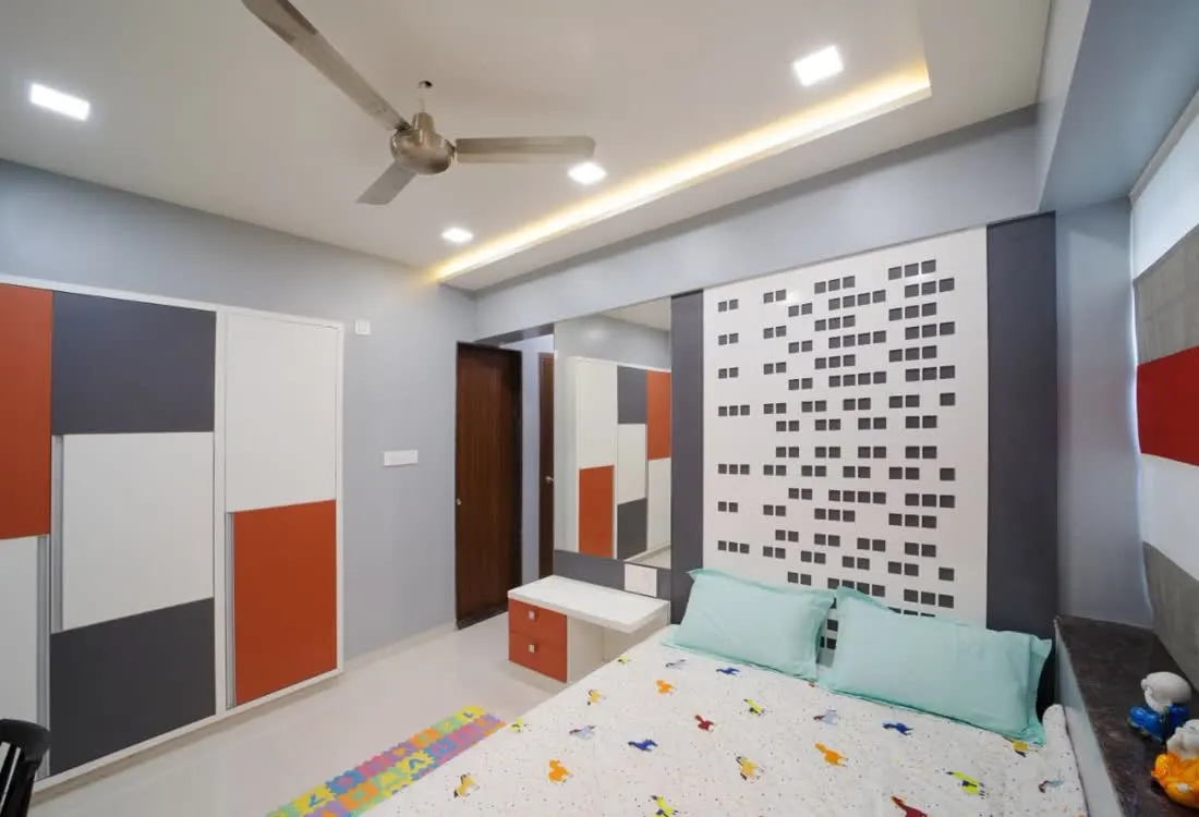 Custom wardrobe with coral accent panels in a bedroom