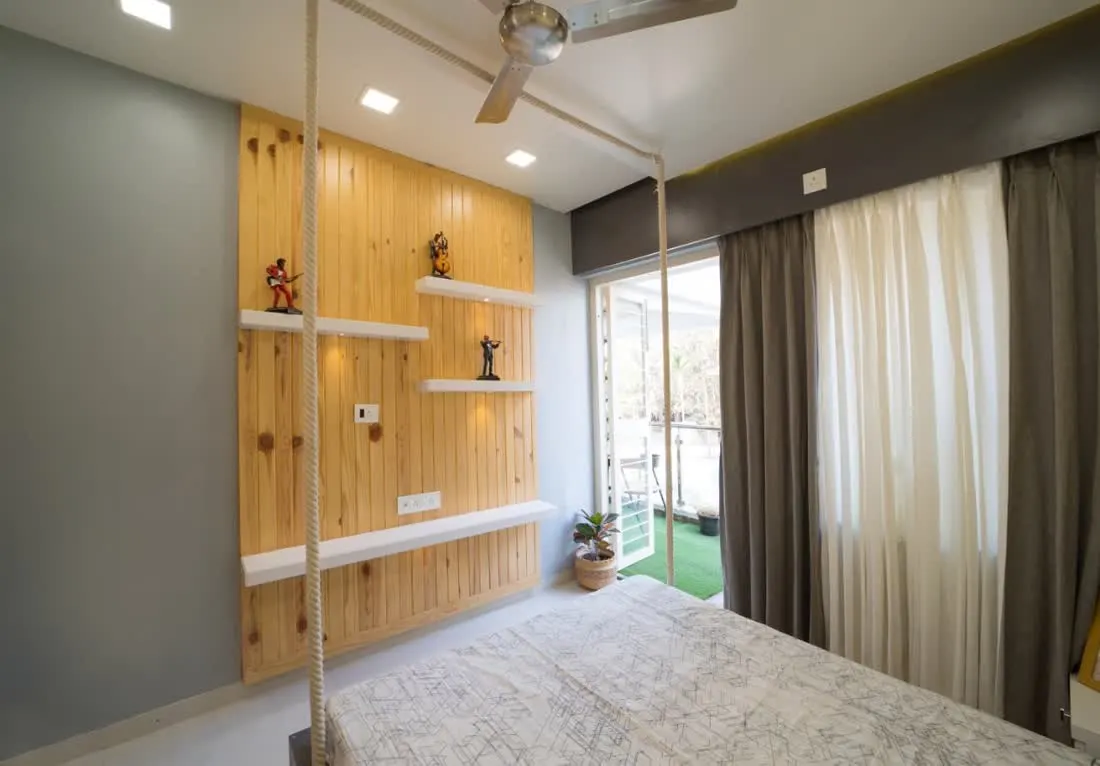 Bedroom with suspended rope bed and wood slatted wall