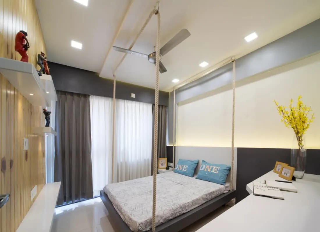 Bedroom with suspended bed and long study desk along wood slatted wall