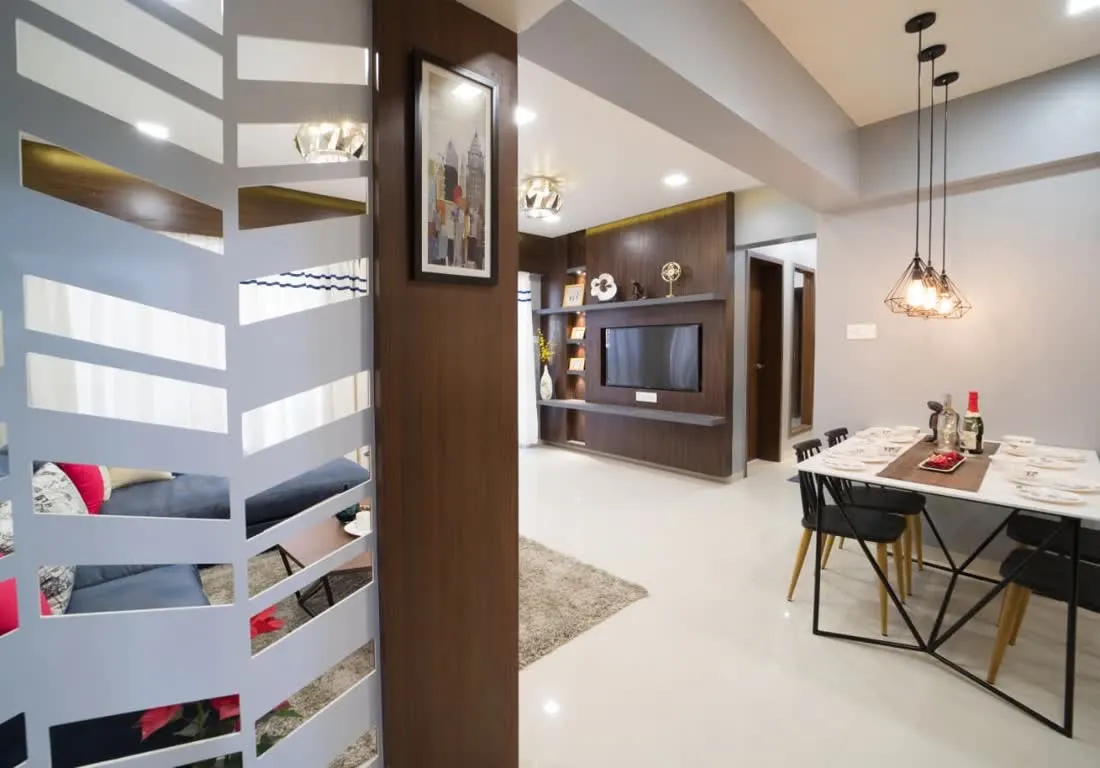 Living and dining space with custom partition designed by DesignGypsy