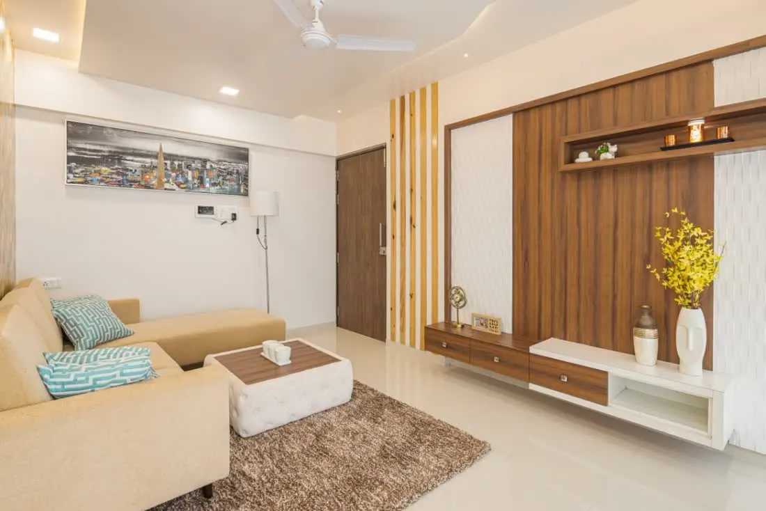 Living room with TV console unit and beige seating