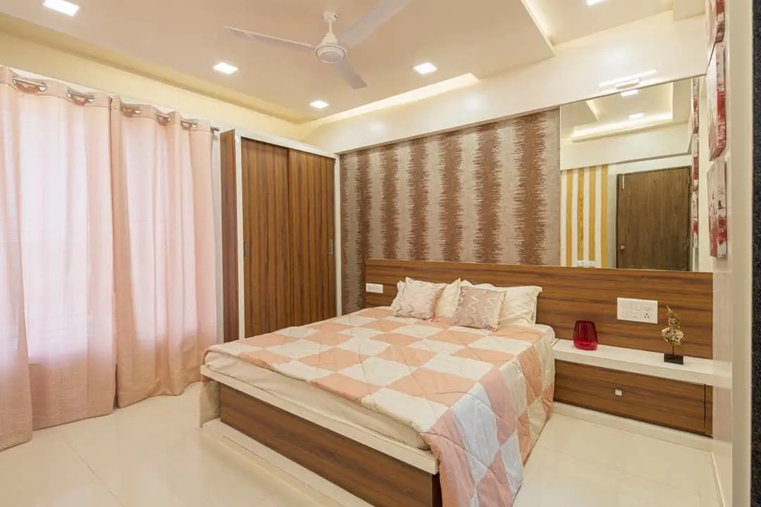 Master bedroom with wood panelled headboard and sliding wardrobe