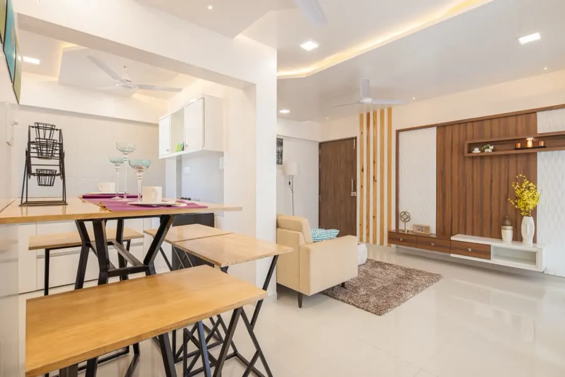 Open concept living and dining area with light wood benches